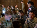 Airmen with the Washington Air National Guard and the Royal Thai Air Force work alongside their RTAF counterparts in small groups to finalize their respective training objectives at the Enduring Partners 2025 final planning conference in Spokane, Wash., May 20, 2025. The working groups focused on areas such as air operations, ground-controlled interception, Air Force Special Warfare, cyber, combat communication, humanitarian assistance and disaster relief medical logistics, intel, and space.