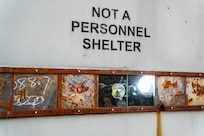 PUMPKIN NECK, Va. — This is not a personnel shelter! It is an armored facility designed to protect high-speed cameras and data acquisition systems from explosions and debris produced by test items. The cameras, along with attached high-power LED lights, are visible through bulletproof glass. Additionally, the other metal panels can be removed or adjusted to create more window space for extra cameras if needed. (Dorina Watermolen/NSWCDD Photo)