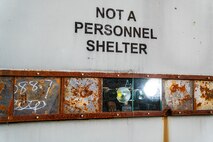 PUMPKIN NECK, Va. — This is not a personnel shelter! It is an armored facility designed to protect high-speed cameras and data acquisition systems from explosions and debris produced by test items. The cameras, along with attached high-power LED lights, are visible through bulletproof glass. Additionally, the other metal panels can be removed or adjusted to create more window space for extra cameras if needed. (Dorina Watermolen/NSWCDD Photo)