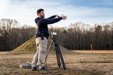 PUMPKIN NECK, Va. — Spencer Gray, an instrumentation technician at the Integrated Engagement Systems Department, sets and adjusts a video camera before a test event at the Naval Surface Warfare Center Dahlgren Division’s Explosive Experimental Area. (Dorina Watermolen/NSWCDD Photo)