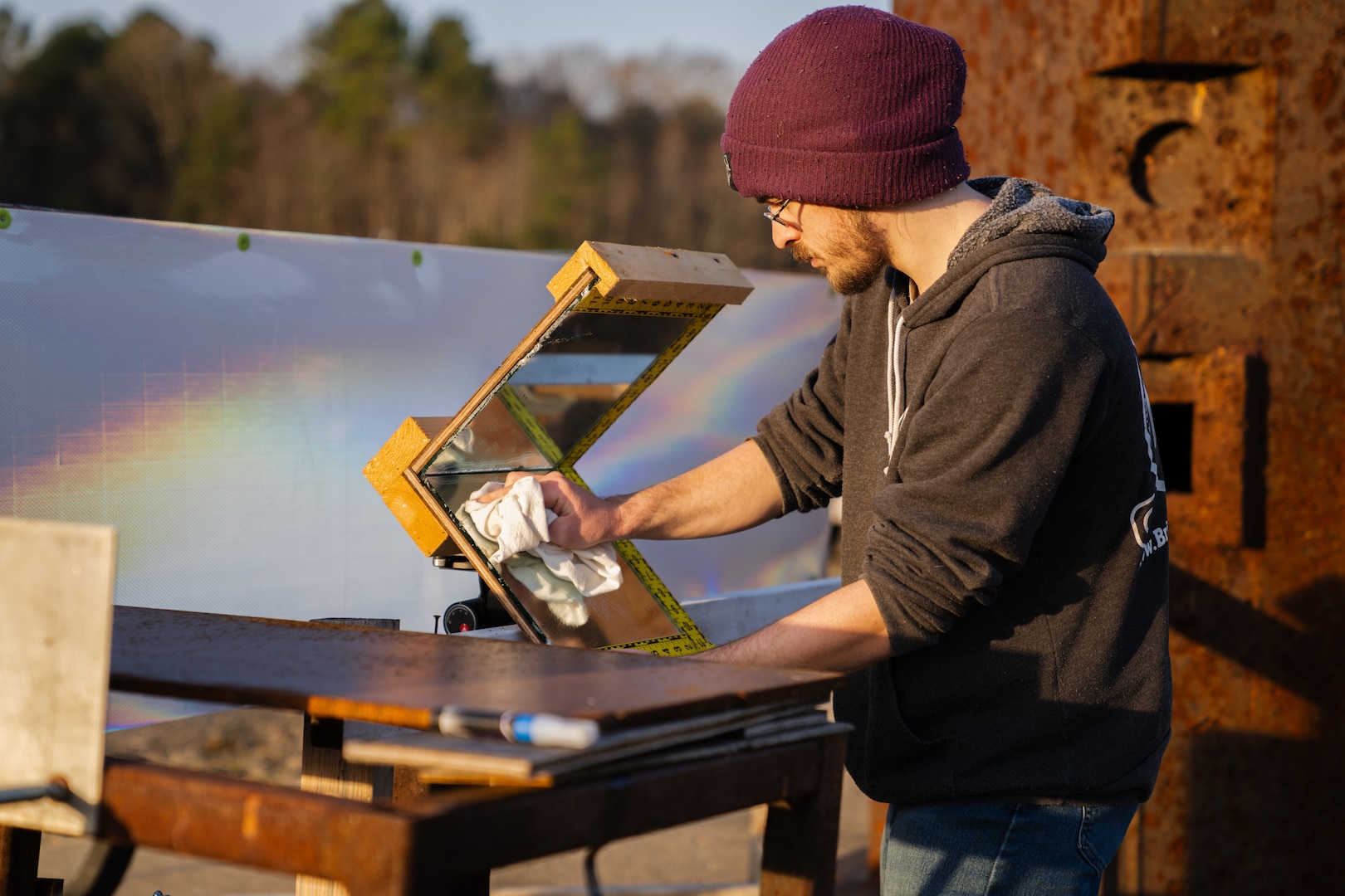 PUMPKIN NECK, Va. — Kevin Richardson, an instrumentation technician at the Naval Surface Warfare Center Dahlgren Division’s Integrated Engagement Systems Department, cleans and adjusts a set of retroreflective mirrors. These mirrors are used in conjunction with high-speed cameras to measure the pitch, roll and yaw of fragments fired from a gun before they impact a test item. (Dorina Watermolen/NSWCDD Photo)