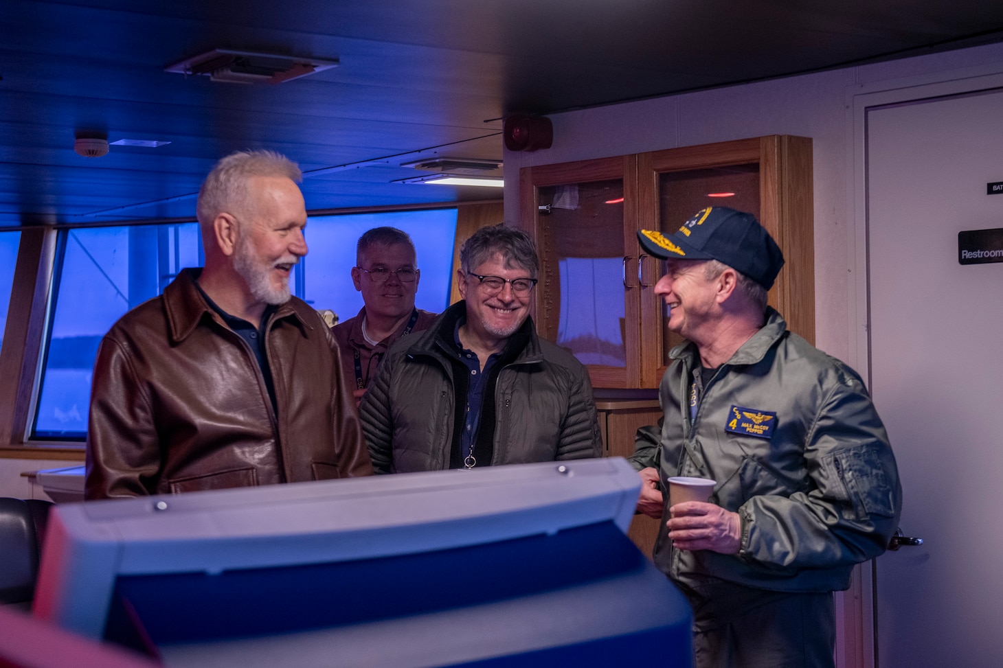 Rear Admiral Max McCoy, commander, Carrier Strike Group Four (CSG-4), right, meets with Capt. Mike Schoeller, left, master of Training Support Vessel (TSV) 5 Vindicator, and the Training Support Vessel Squadron (TSVRON) 4 team.