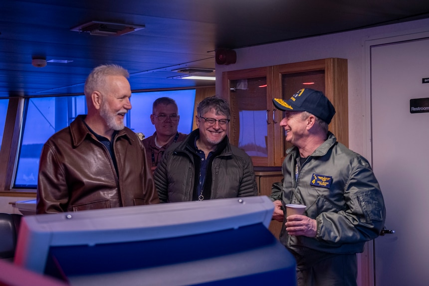 Rear Admiral Max McCoy, commander, Carrier Strike Group Four (CSG-4), right, meets with Capt. Mike Schoeller, left, master of Training Support Vessel (TSV) 5 Vindicator, and the Training Support Vessel Squadron (TSVRON) 4 team.