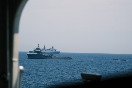The amphibious transport dock USS San Antonio (LPD 17) maneuvers as two rigid-hulled inflatable boats (RHIB) prepare to board Training Support Vessel (TSV) Vindicator (TSV 5), assigned to Training Support Vessel Squadron (TSVRON) 4, during a visit, board, search and seizure (VBSS) joint exercise during the Iwo Jima Amphibious Ready Group Marine Expeditionary Unit Exercise (ARGMEUEX) in the Atlantic Ocean, May 18, 2025.