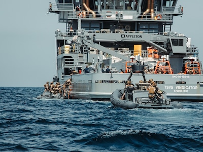 U.S. Marines with Maritime Special Purpose Force, 22nd Marine Expeditionary Unit, board a vessel in rigid-hull inflatable boats while conducting maritime interception operations aboard U.S. Navy training support vessel USNS Vindicator (TSV5) in support of Iwo Jima Amphibious Ready Group Marine Expeditionary Unit Exercise (ARGMEUEX) while underway in the Atlantic Ocean, May 18, 2025.