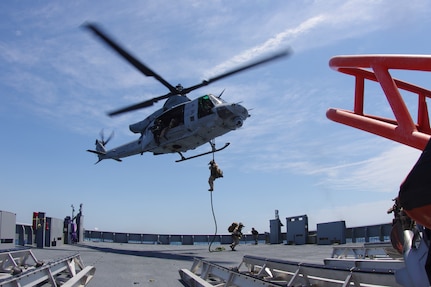 U.S. Marines with Maritime Special Purpose Force, 22nd Marine Expeditionary Unit, fast rope from a U.S. Navy MH-60S Seahawk Helicopter assigned to Helicopter Combat Squadron 26 during visit board search and seizure operations aboard U.S. Navy training support vessel (TSV) Vindicator (TSV 5), assigned to Training Support Vessel Squadron (TSVRON) 4, during the Iwo Jima Amphibious Ready Group Marine Expeditionary Unit Exercise (ARGMEUEX) in the Atlantic Ocean, May 18, 2025.