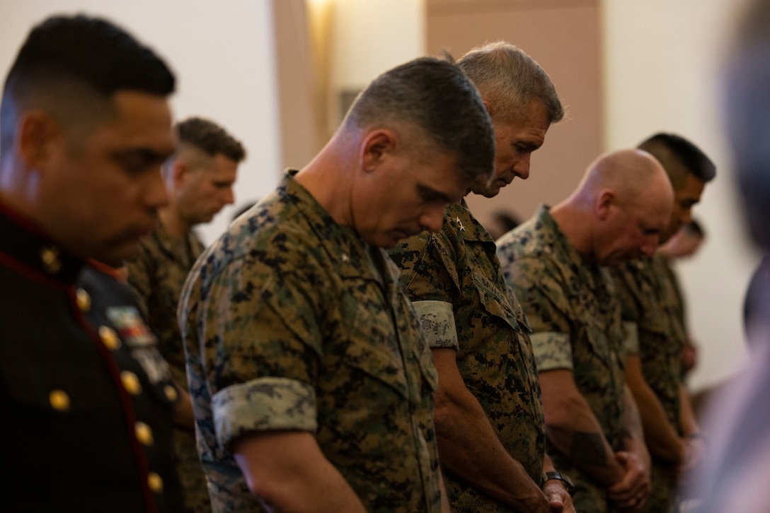 U.S. Marine Corps Brig. Gen. Jeremy Winters, left, the deputy commanding general of operations for Joint Task Force - Southern Border, and Maj. Gen. Thomas B. Savage, the commanding general of 1st Marine Division, bow their heads during the benediction at the memorial service of two fallen Marines at the chapel at Marine Corps Air Station Miramar, California, May 22, 2025. The memorial service was held in honor of Lance Cpl. Albert A. Aguilera and Lance Cpl. Marcelino M. Gamino, who lost their lives in the line of duty April 15, 2025. (U.S. Marine Corps photo by Lance Cpl. Nataly Espitia)