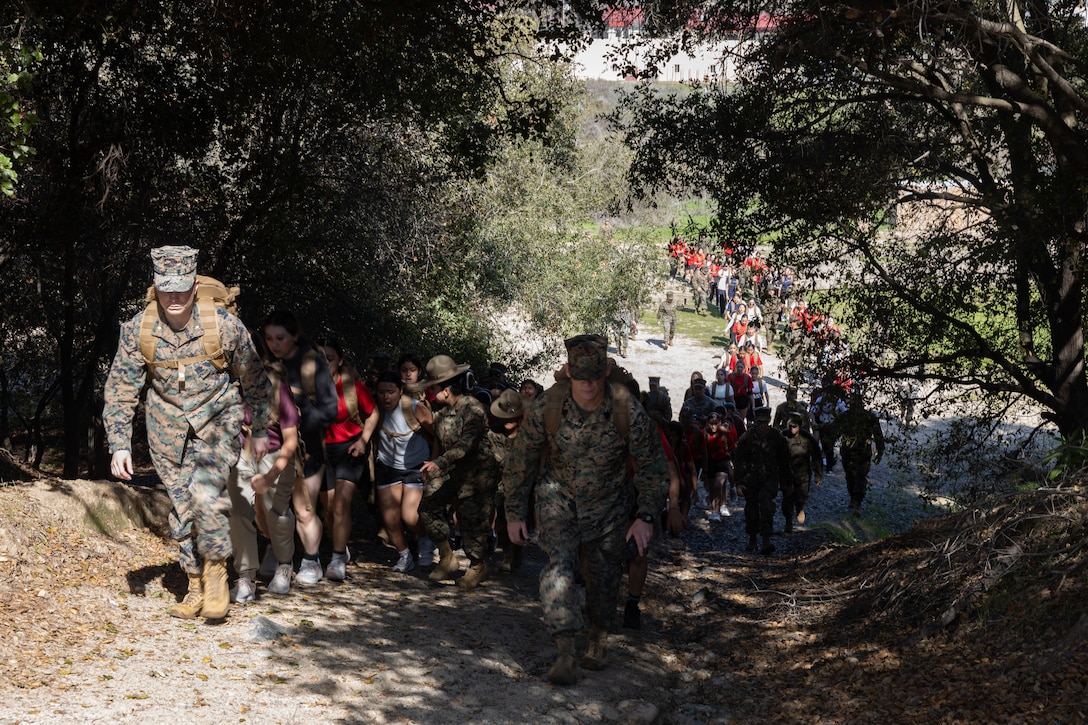 U.S. Marines and poolees with Recruiting Station Orange County and RS San Diego participate in a hike during a pool function at Marine Corps Base Camp Pendleton in Oceanside, California, March 22, 2025. Pool functions are held to build camaraderie and heathy competition while preparing poolees for the mental and physical rigors of recruit training. (U.S. Marine Corps photo by Sgt. Fred Garcia)