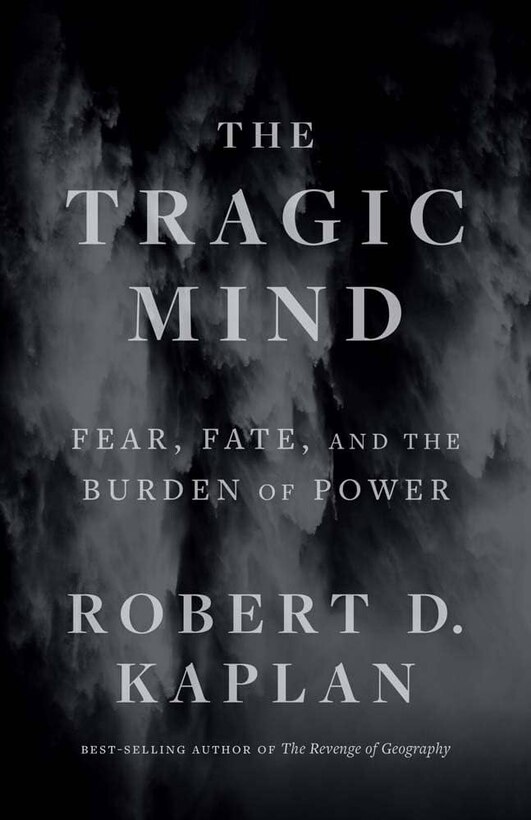 Book cover titled "The Tragic Mind: Fear, Fate, and the Burden of Power" by Robert D. Kaplan, best-selling author of The Revenge of Geography. The background features a dark, stormy, abstract texture with gray and black tones, evoking a somber and contemplative mood. The title and author’s name are displayed in large, serif font across the center of the cover.