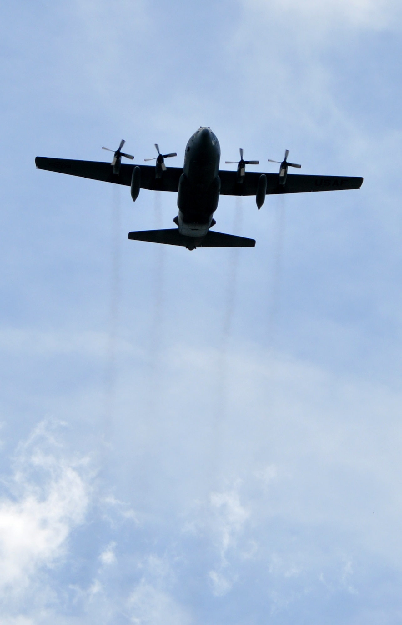 A C-130H Hercules aircraft, assigned to the 910th Airlift Wing at nearby Youngstown Air Reserve Station, Ohio, approaches the Cortland Triangle in Cortland, Ohio, for a flyover of the city’s Memorial Day ceremony on May 26, 2025.