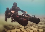 Two divers utilize a dual frame Seacraft diver propulsion vehicle (DPV) during operations at sea. The DPV can be used as a linear tow or can quickly be decoupled to transform into a vehicle for each of these divers based on mission requirements. (courtesy photo)