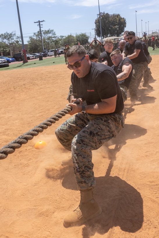 U.S. Marines with Marine Fighter Attack Squadron (VMFA) 311, Marine Aircraft Group 11, 3rd Marine Aircraft Wing, compete in a tug-of-war event during the annual MAG-11 warrior games at Marine Corps Air Station Miramar, California, May 22, 2025.