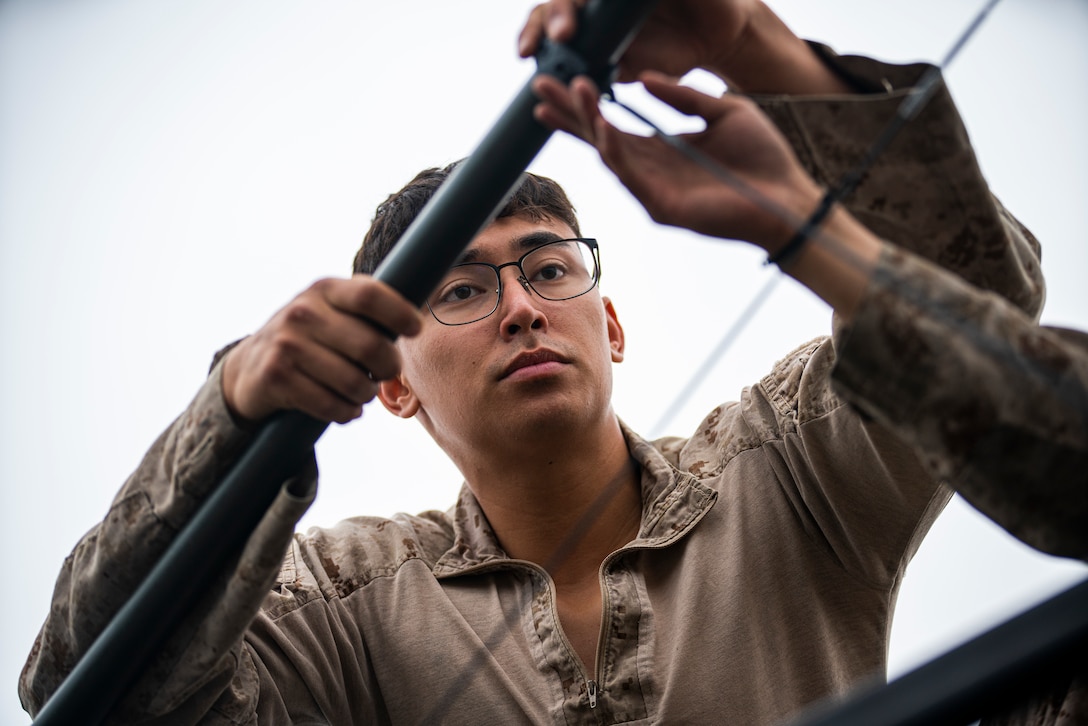 U.S. Marine Corps Cpl. Jomar Krienke, an amphibious combat vehicle crewman with Alpha Company, 3rd Assault Amphibian Battalion, 1st Marine Division, fastens an antenna on an ACV before an open-water transit to the amphibious dock landing ship USS Harpers Ferry (LSD 49) during Quarterly Underway Amphibious Readiness Training 25.3 at Marine Corps Base Camp Pendleton, California, May 28, 2025. QUART is a joint training exercise designed to develop and sustain essential amphibious readiness skills for effective operations in maritime environments while reinforcing the Navy-Marine Corps partnership. Krienke is a native of Minnesota. (U.S. Marine Corps photo by Staff Sgt. Dylan Chagnon)