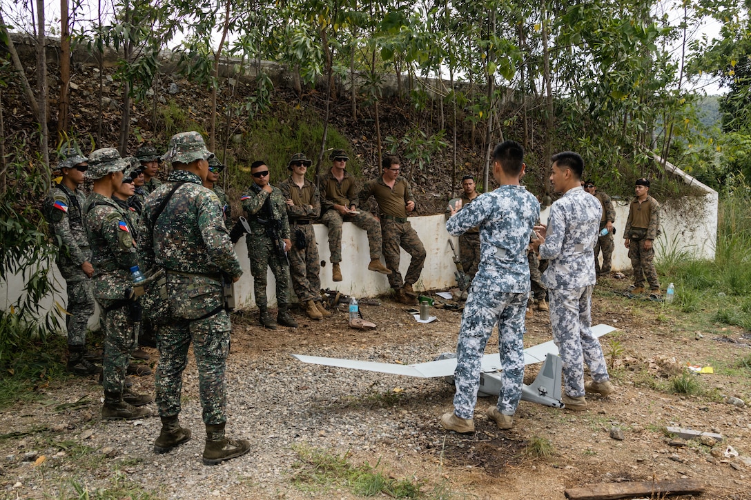 Philippine Coast Guardsmen instruct on the uses of a drone to Philippine Marines and U.S. Marines with 2nd Battalion, 1st Marine Regiment, Marine Rotational Force – Darwin 25.3, during KAMANDAG 9 at Oyster Bay, Palawan, Philippines, May 28, 2025.