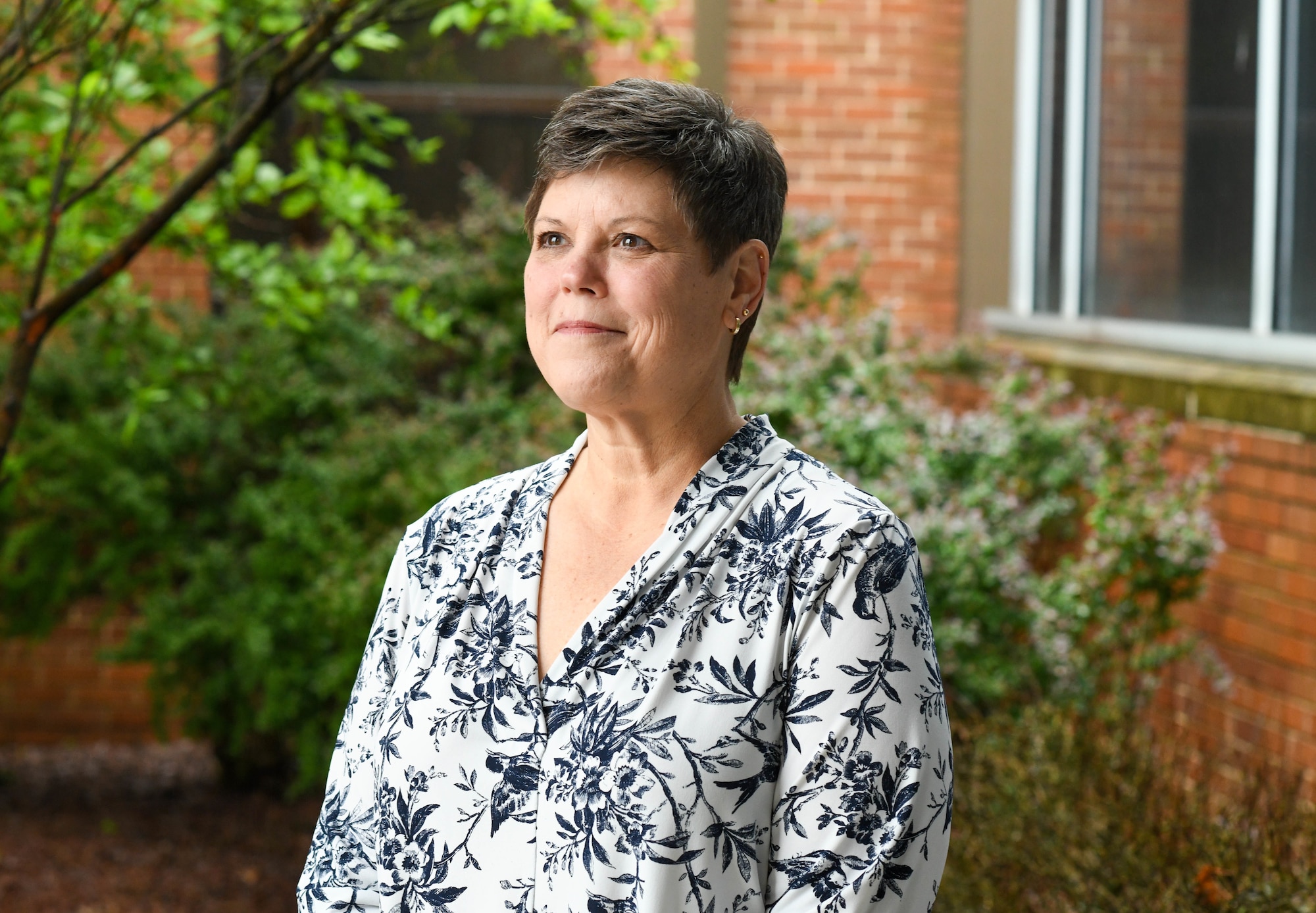 Terri Ann Naughton, 910th Airlift Wing director of psychological health, poses for a photo outside of the wing headquarters building on May 22, 2025, at Youngstown Air Reserve Station, Ohio.