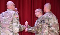 CW5 John P. Peart assumes responsibility during a Change of Charter ceremony
