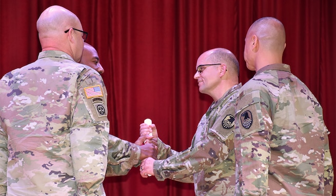 CW5 John P. Peart assumes responsibility during a Change of Charter ceremony