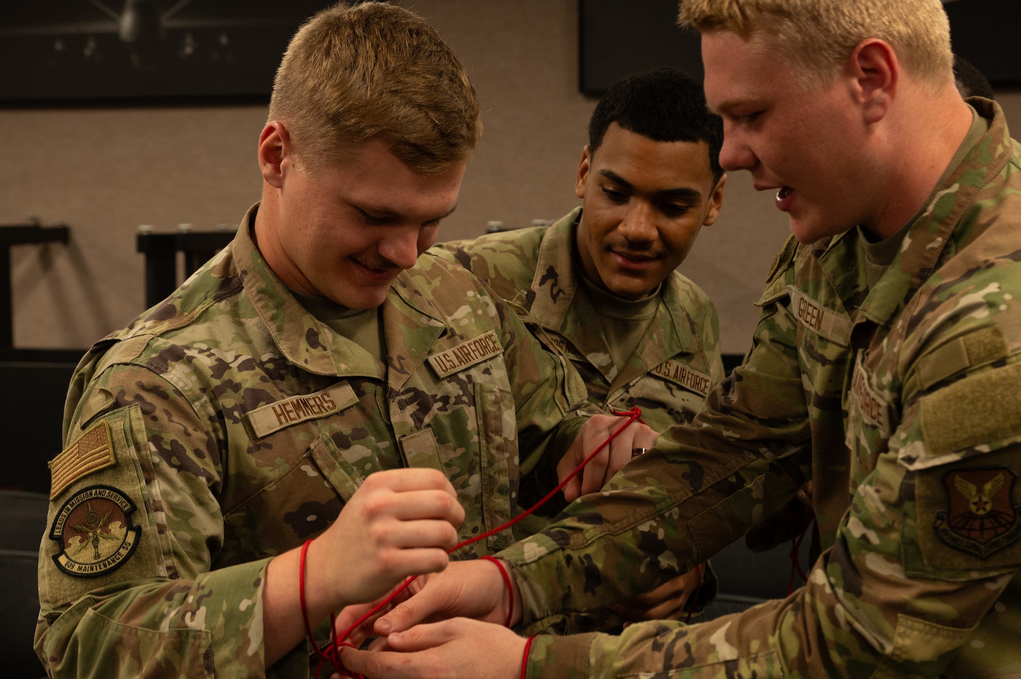 First Term Airmen perform a team building exercise during a Wingman Guardian Connect class at Whiteman Air Force Base, Missouri, May 13, 2025. The WGC program is designed for FTA and incorporates workshops, team activities and open discussions to encourage social connection and strengthen resilience. (U.S. Air Force photo by Senior Airman Joseph Garcia)