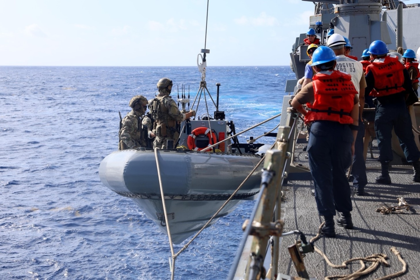 Coast Guardsmen assigned to U.S. Coast Guard Law Enforcement Detachment (LEDET) 401, embarked on the Arleigh Burke-class guided-missile destroyer USS Gravely (DDG 107), board the ship’s ridged hull inflatable boat to conduct maritime interdiction operations (MIO), while underway in the Caribbean Sea.
