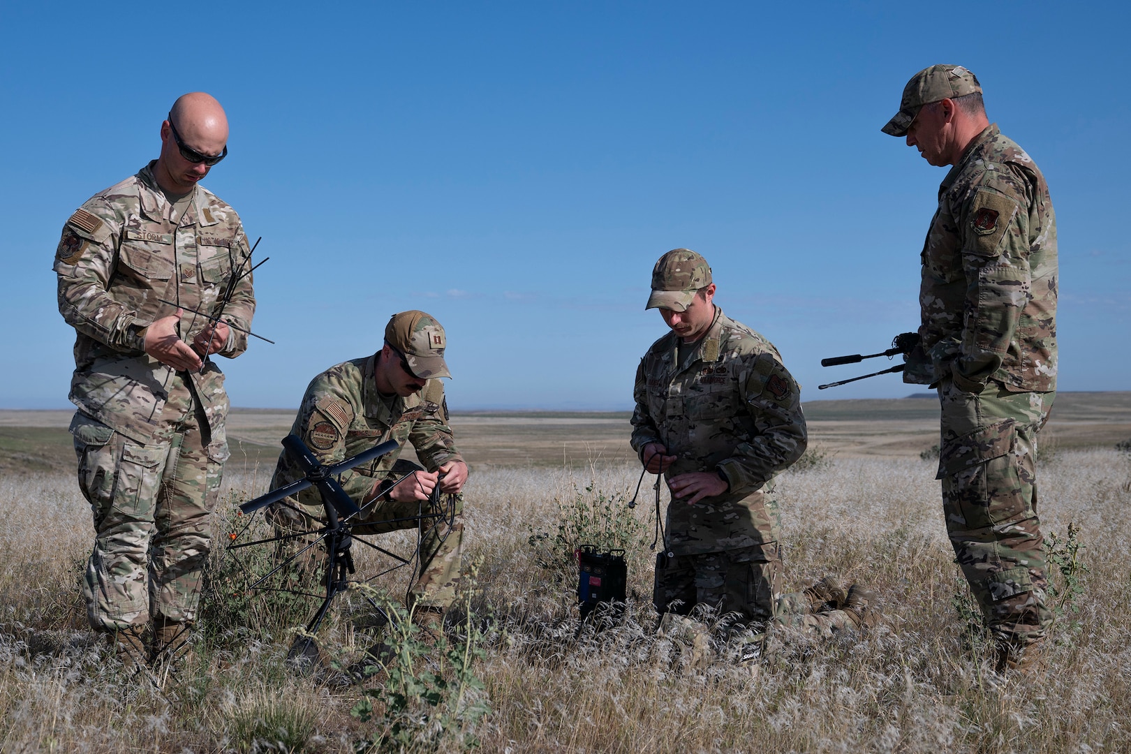 U.S. Air Force Warrant Officer Jason Oakes (second from right), warfighter communications with the 194th Communication Squadron, Washington Air National Guard, and fellow Airmen with the 194th Wing, assemble a Mobile User Objective System antenna during Exercise Phoenix Dawn 2025 at Saylor Creek Range near Mountain Home Air Force Base, Idaho, May 6, 2025.