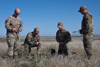 U.S. Air Force Warrant Officer Jason Oakes (second from right), warfighter communications with the 194th Communication Squadron, Washington Air National Guard, and fellow Airmen with the 194th Wing, assemble a Mobile User Objective System antenna during Exercise Phoenix Dawn 2025 at Saylor Creek Range near Mountain Home Air Force Base, Idaho, May 6, 2025.