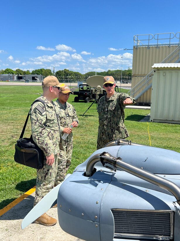U.S. Naval Forces Southern Command / U.S. 4th Fleet Commander Rear Adm. Carlos Sardiello, right, discusses the Resolute Eagle unmanned aircraft system (UAS) with Joint Interagency Task Force-South Deputy Director, Rear Adm. Chase Sargeant, left, and Cooperative Security Location (CSL) Comalapa Commanding Officer Cmdr. Victor Barba, center, during the Hybrid Fleet Campaign (HFC) Fleet Experiment (FLEX) showcase event at CSL Comalapa near San Salvador, El Salvador, May 27, 2025. HFC is a learning campaign to retain and improve advantages using next-generation manned and unmanned systems, tested and integrated during and after FLEX. U.S. Naval Forces Southern Command/U.S. 4th Fleet is the maritime component of U.S. Southern Command and the trusted maritime partner for Caribbean, Central and South America maritime forces leading to improved unity, security and stability.