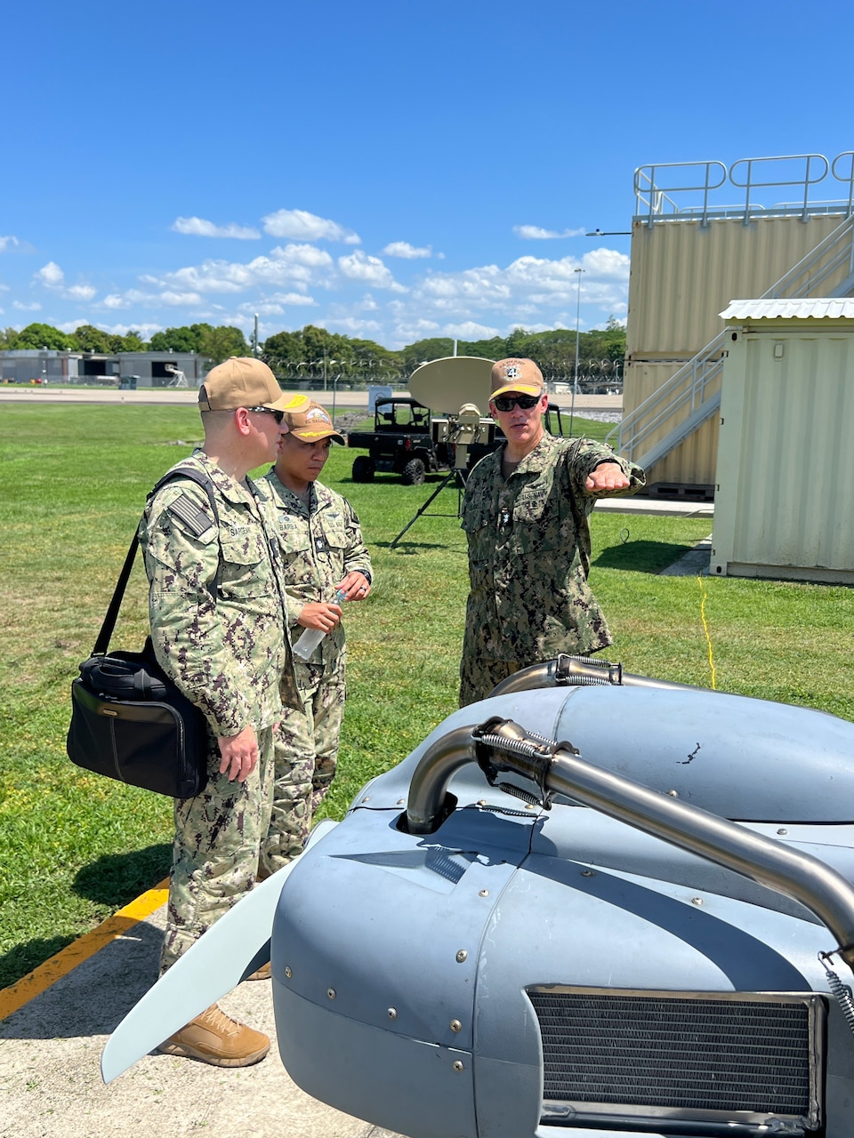 U.S. Naval Forces Southern Command / U.S. 4th Fleet Commander Rear Adm. Carlos Sardiello, right, discusses the Resolute Eagle unmanned aircraft system (UAS) with Joint Interagency Task Force-South Deputy Director, Rear Adm. Chase Sargeant, left, and Cooperative Security Location (CSL) Comalapa Commanding Officer Cmdr. Victor Barba, center, during the Hybrid Fleet Campaign (HFC) Fleet Experiment (FLEX) showcase event at CSL Comalapa near San Salvador, El Salvador, May 27, 2025. HFC is a learning campaign to retain and improve advantages using next-generation manned and unmanned systems, tested and integrated during and after FLEX. U.S. Naval Forces Southern Command/U.S. 4th Fleet is the maritime component of U.S. Southern Command and the trusted maritime partner for Caribbean, Central and South America maritime forces leading to improved unity, security and stability.
