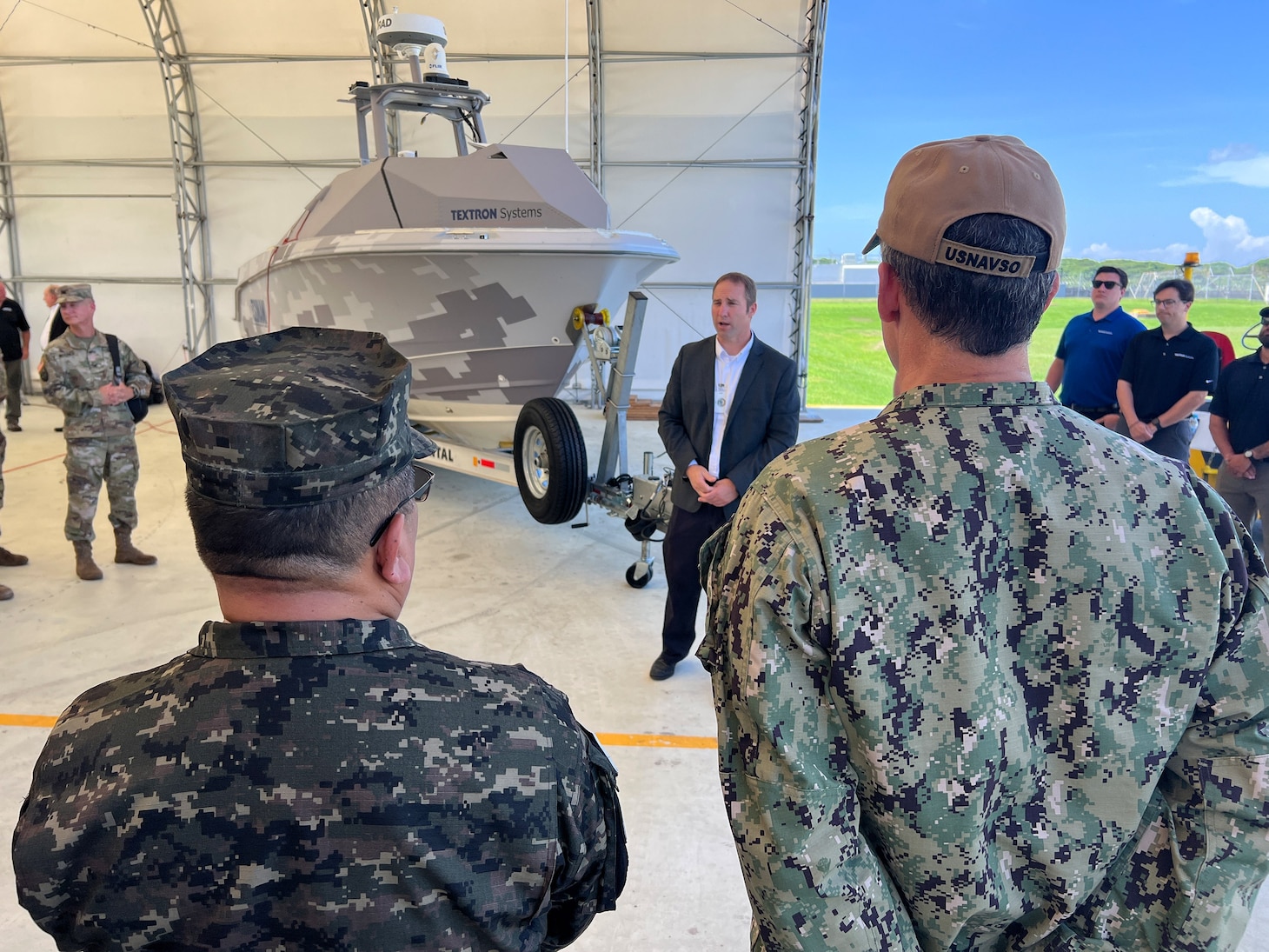 Captain of the Salvadoran Navy, Capt. Omar Hernandez, left, and U.S. Naval Forces Southern Command / U.S. 4th Fleet Commander Rear Adm. Carlos Sardiello, right, receive a Tsunami unmanned surface vessel (USV) capabilities overview during the Hybrid Fleet Campaign (HFC) Fleet Experiment (FLEX)’s showcase event at CSL Comalapa near San Salvador, El Salvador, May 27, 2025. HFC is a learning campaign to retain and improve advantages using next-generation manned and unmanned systems, tested and integrated during and after FLEX. U.S. Naval Forces Southern Command/U.S. 4th Fleet is the maritime component of U.S. Southern Command and the trusted maritime partner for Caribbean, Central and South America maritime forces leading to improved unity, security and stability.