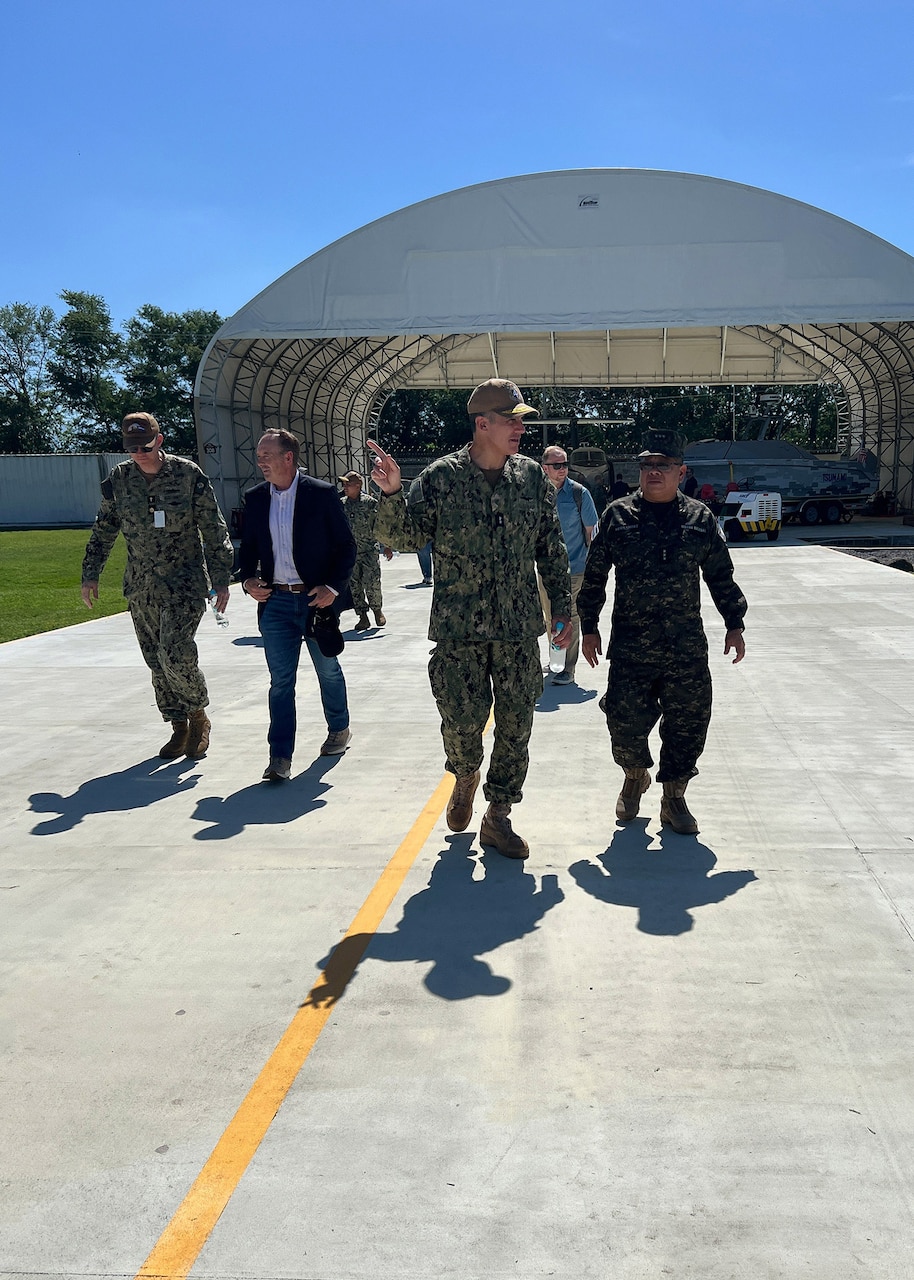 U.S. Naval Forces Southern Command / U.S. 4th Fleet Commander Rear Adm. Carlos Sardiello, left-of-center, and Captain of the Salvadoran Navy, Capt. Omar Hernandez, right-of-center, discuss interoperability tests between the Salvadoran Navy and  Hybrid Fleet Campaign (HFC) Fleet Experiment (FLEX)’s manned and unmanned systems as they transit between stations during the FLEX showcase event at CSL Comalapa near San Salvador, El Salvador, May 27, 2025. HFC is a learning campaign to retain and improve advantages using next-generation manned and unmanned systems, tested and integrated during and after FLEX. U.S. Naval Forces Southern Command/U.S. 4th Fleet is the maritime component of U.S. Southern Command and the trusted maritime partner for Caribbean, Central and South America maritime forces leading to improved unity, security and stability.