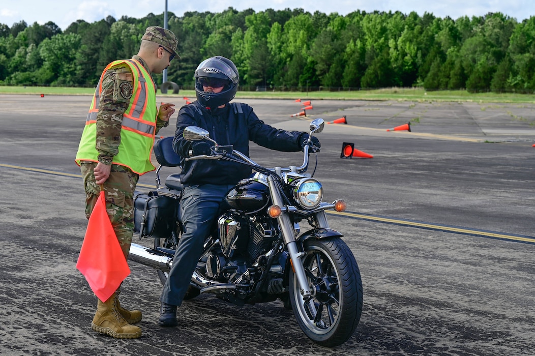 A man talking to a motorcycle rider.
