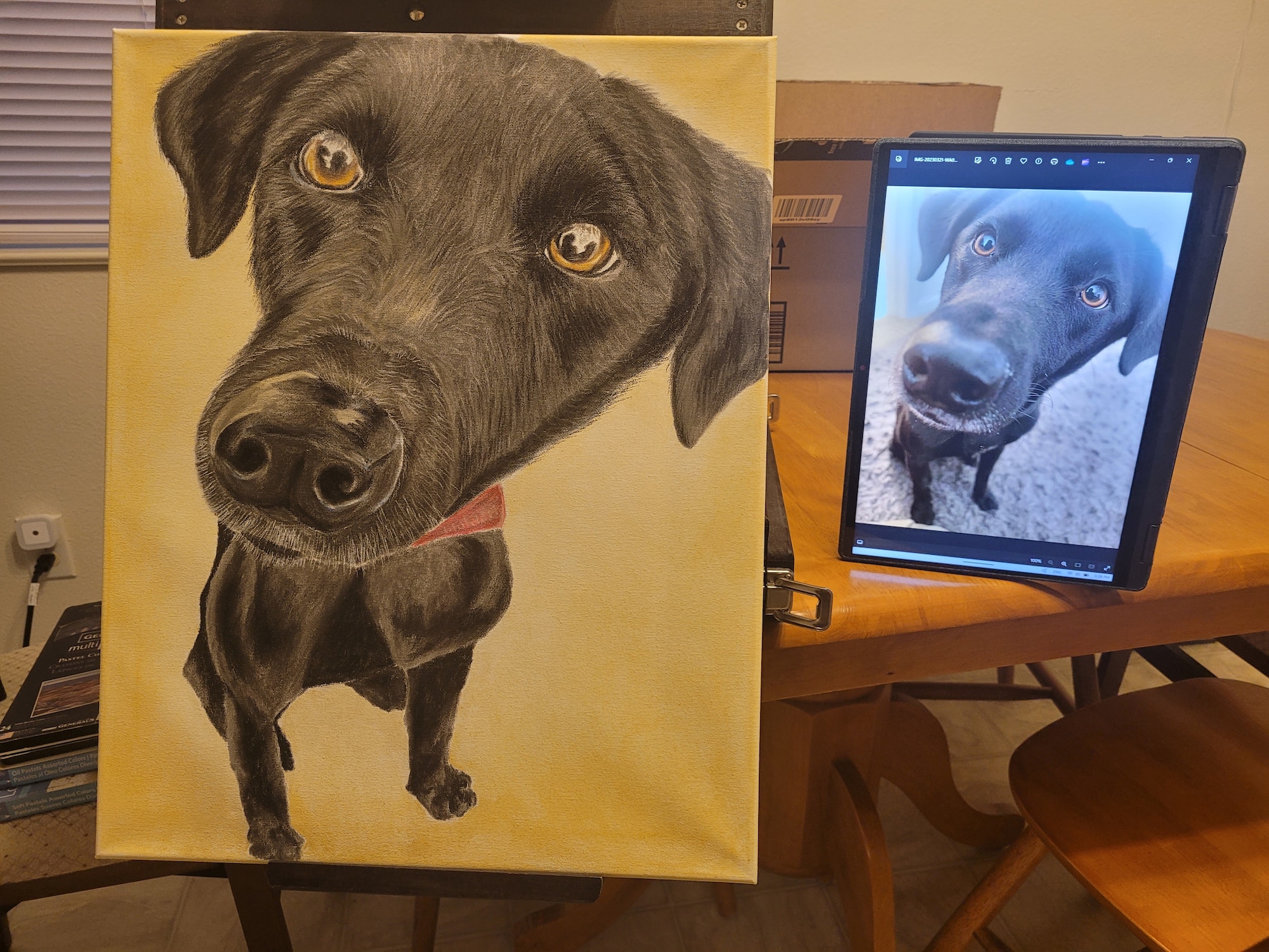 A custom pet portrait rests on an easel next to the original photo at Joint Base Lewis-McChord, Washington, Feb. 29, 2024.