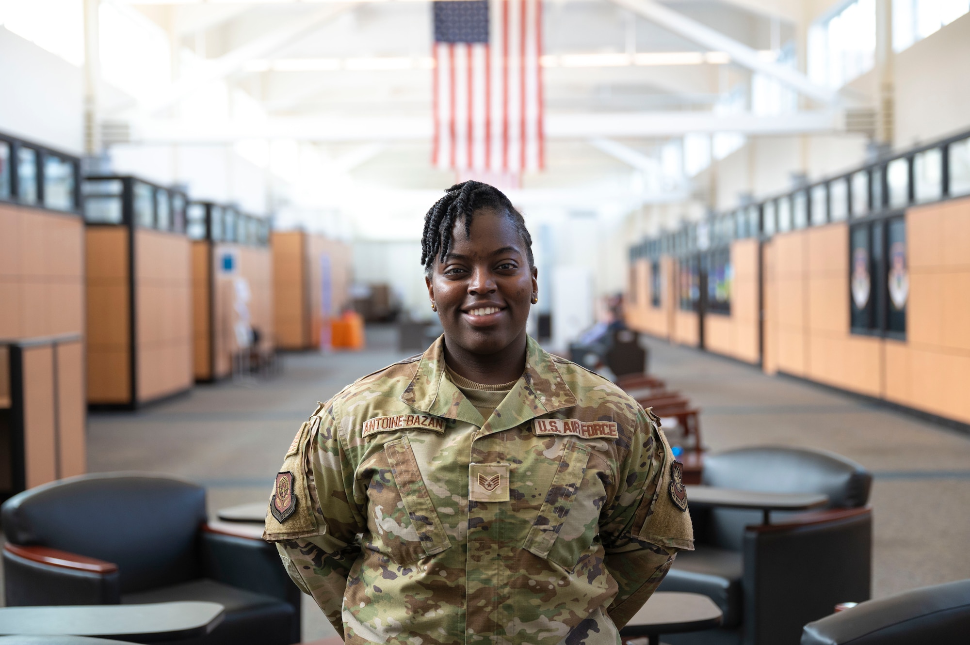 U.S. Air Force Staff Sgt. Briana Antoine-Bazan, 62d Airlift Wing protocol NCO in charge, stands in the customer service mall at Joint Base Lewis-McChord, Washington, Feb. 19, 2025.