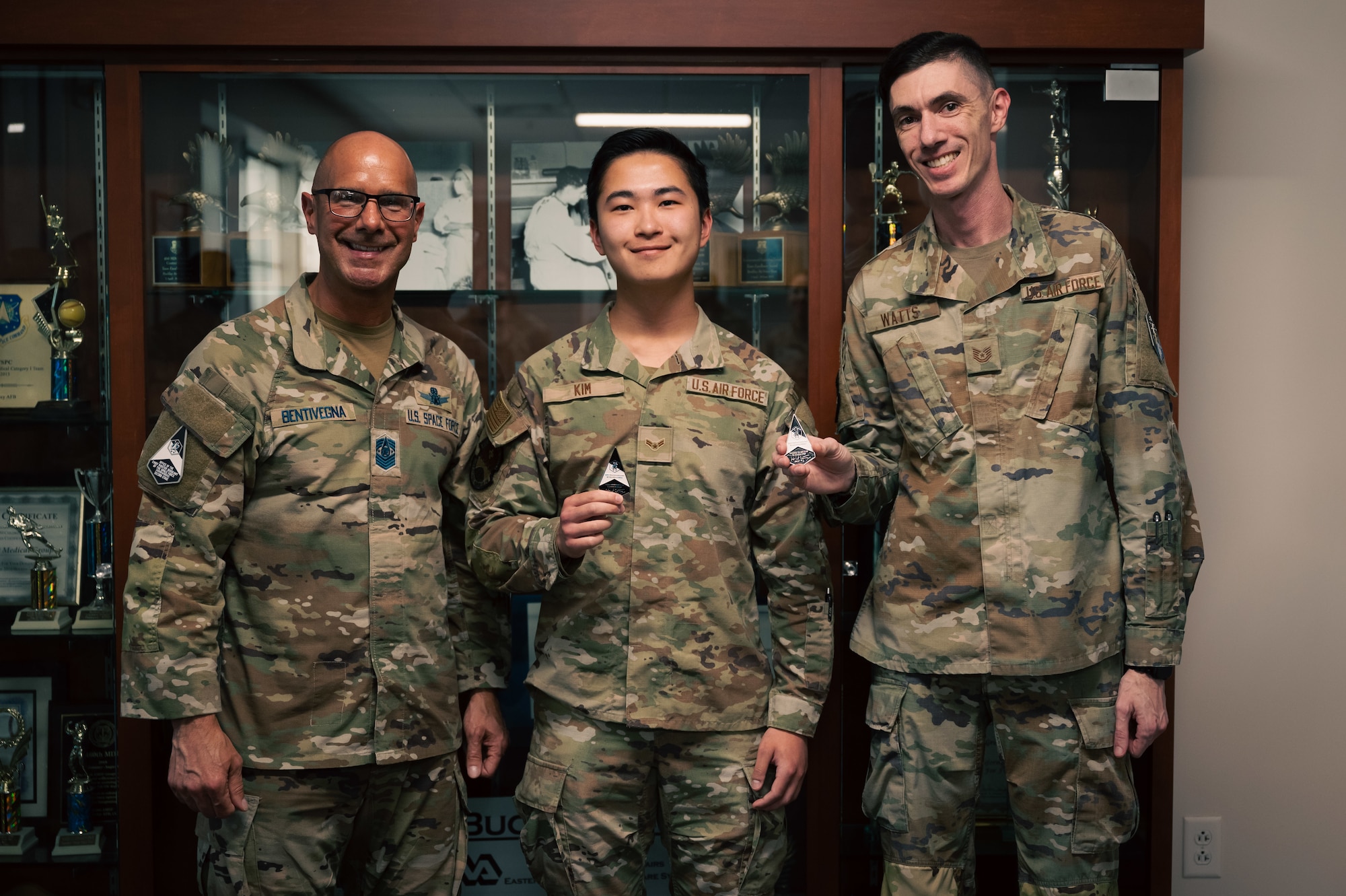 three men pose for a photo