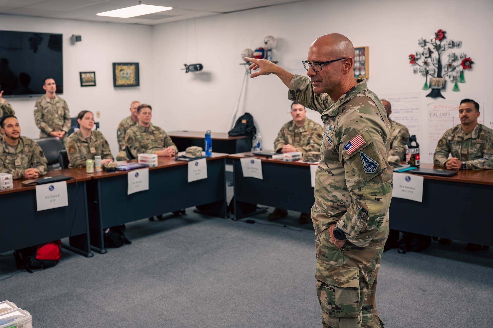 Man speaks to a classroom of military students