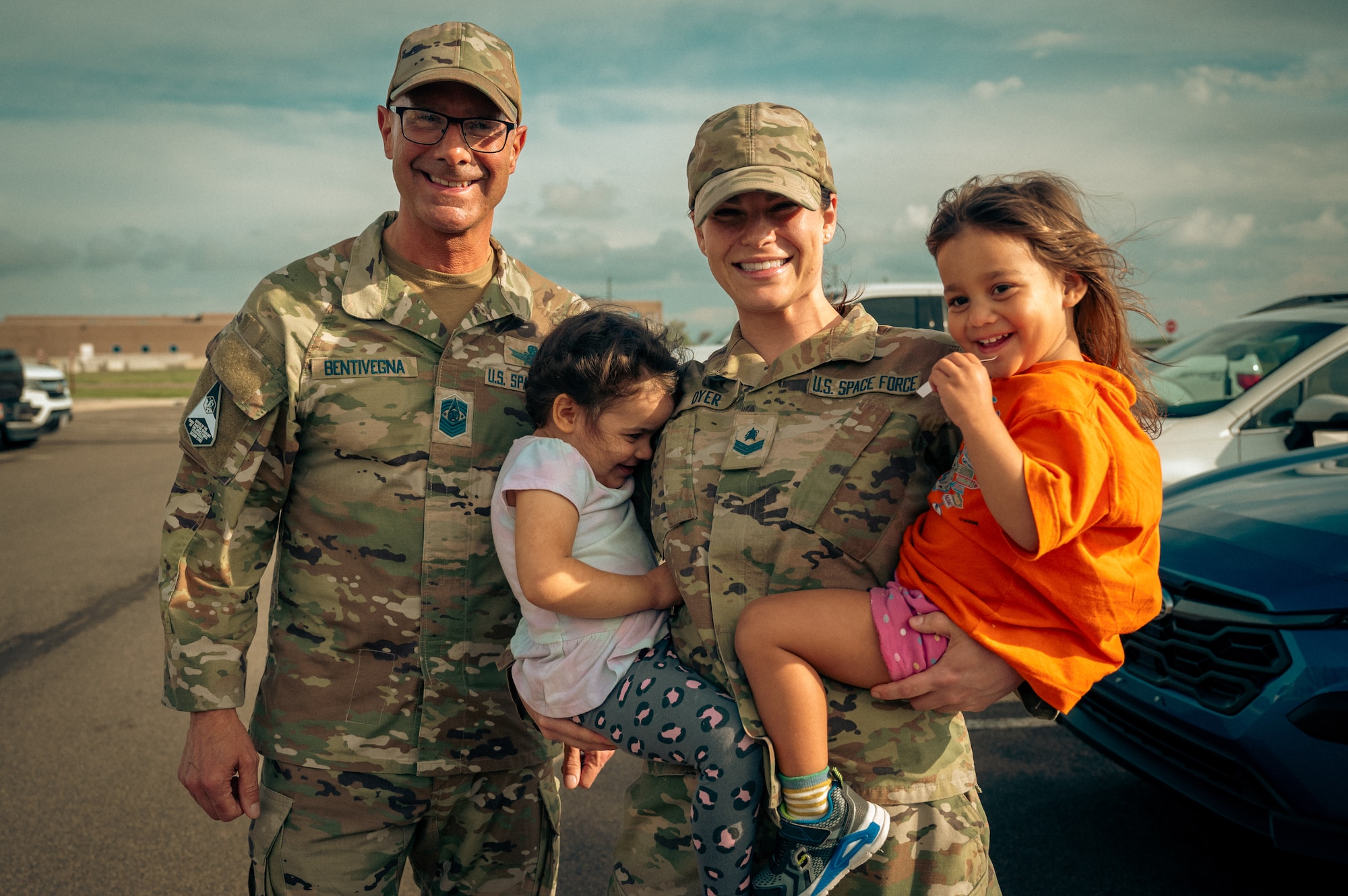man, woman and children pose for a photo