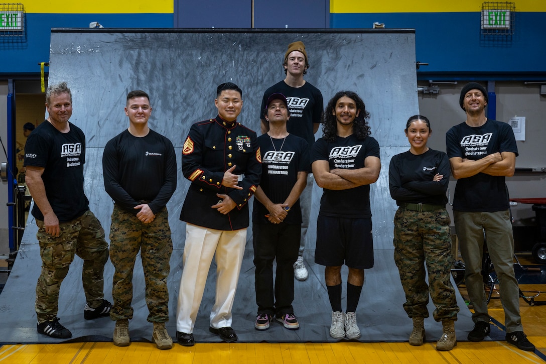 U.S. Marines with Recruiting Station Seattle pose for a group photograph with BMX riders during an Action Sports Association No Hate Tour event at Hazen High School in Renton, Washington, April 14, 2025. The ASA No Hate Tour, now in its 25th year, is an educational program that uses the energy and excitement of action sports to deliver critical bullying prevention tools, techniques, and information to students. (U.S. Marine Corps photo by Sgt. Hunter Wagner)