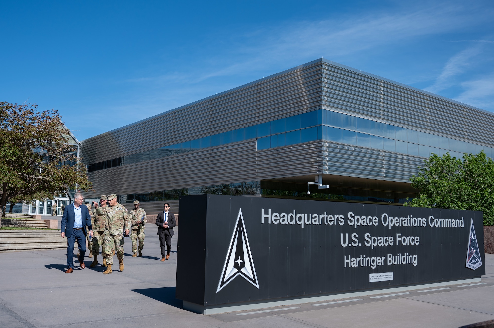 Secretary of the Air Force Troy Meink (left) walks with U.S. Space Force Lt. Gen. David N. Miller, Jr. (pointing ahead), Commander of Space Operations Command, at Peterson Space Force Base, Colorado, May 28, 2025. Space Operations Command Guardians and Airmen demonstrated their combat readiness and warrior ethos, providing Meink with a deep dive into multiple critical mission areas, to include Space Domain Awareness; Electromagnetic Warfare; Missile Warning; Intelligence, Surveillance, Reconnaissance and Targeting; Orbital Warfare and Positioning, Navigation and Timing; as well as the critical mission support provided by the U.S. Air Force.  (U.S. Space Force photo by Dave Grim)