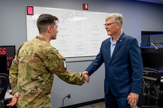  Secretary of the Air Force Troy Meink shakes hands with U.S. Space Force 1st Lt. Callahan McClellan of Space Delta 9 (Orbital Warfare) at Schriever Space Force Base, Colorado, May 28, 2025. Space Operations Command Guardians and Airmen demonstrated their combat readiness and warrior ethos, providing Meink with a deep dive into multiple critical mission areas, to include Space Domain Awareness; Electromagnetic Warfare; Missile Warning; Intelligence, Surveillance, Reconnaissance and Targeting; Orbital Warfare and Positioning, Navigation and Timing; as well as the critical mission support provided by the U.S. Air Force.  (U.S. Space Force photo by Tiana Williams)