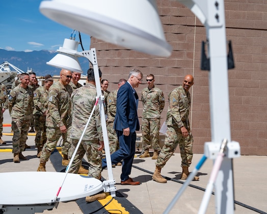  Secretary of the Air Force Troy Meink (center) tours Mission Delta 3 (Electromagnetic Warfare) at Peterson Space Force Base, Colorado, May 28, 2025. Space Operations Command Guardians and Airmen demonstrated their combat readiness and warrior ethos, providing Meink with a deep dive into multiple critical mission areas, to include Space Domain Awareness; Electromagnetic Warfare; Missile Warning; Intelligence, Surveillance, Reconnaissance and Targeting; Orbital Warfare and Positioning, Navigation and Timing; as well as the critical mission support provided by the U.S. Air Force.  (U.S. Space Force photo by Dave Grim)