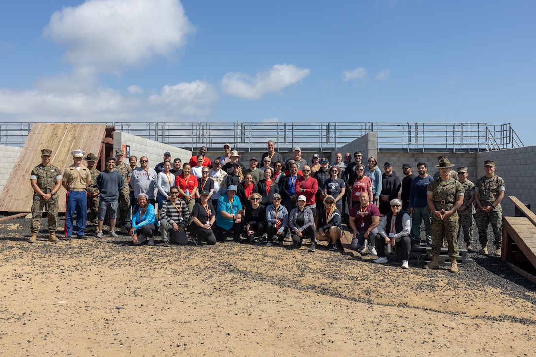 Educators and Marines with 12th Marine Corps District pose for a group photograph during an Educators’ Workshop event at Marine Corps Base Camp Pendleton in Oceanside, California, April 23, 2025. The Educators Workshop program provides selected educators and influential community members with an experiential opportunity to see how the Marine Corps transforms young men and women into Marines. The workshop also provides attendees with current information regarding Marine Corps training practices, military job skills, service opportunities, military lifestyle, and educational benefits available to Marines. (U.S. Marine Corps photo by Cpl. Osmar Gutierrez)