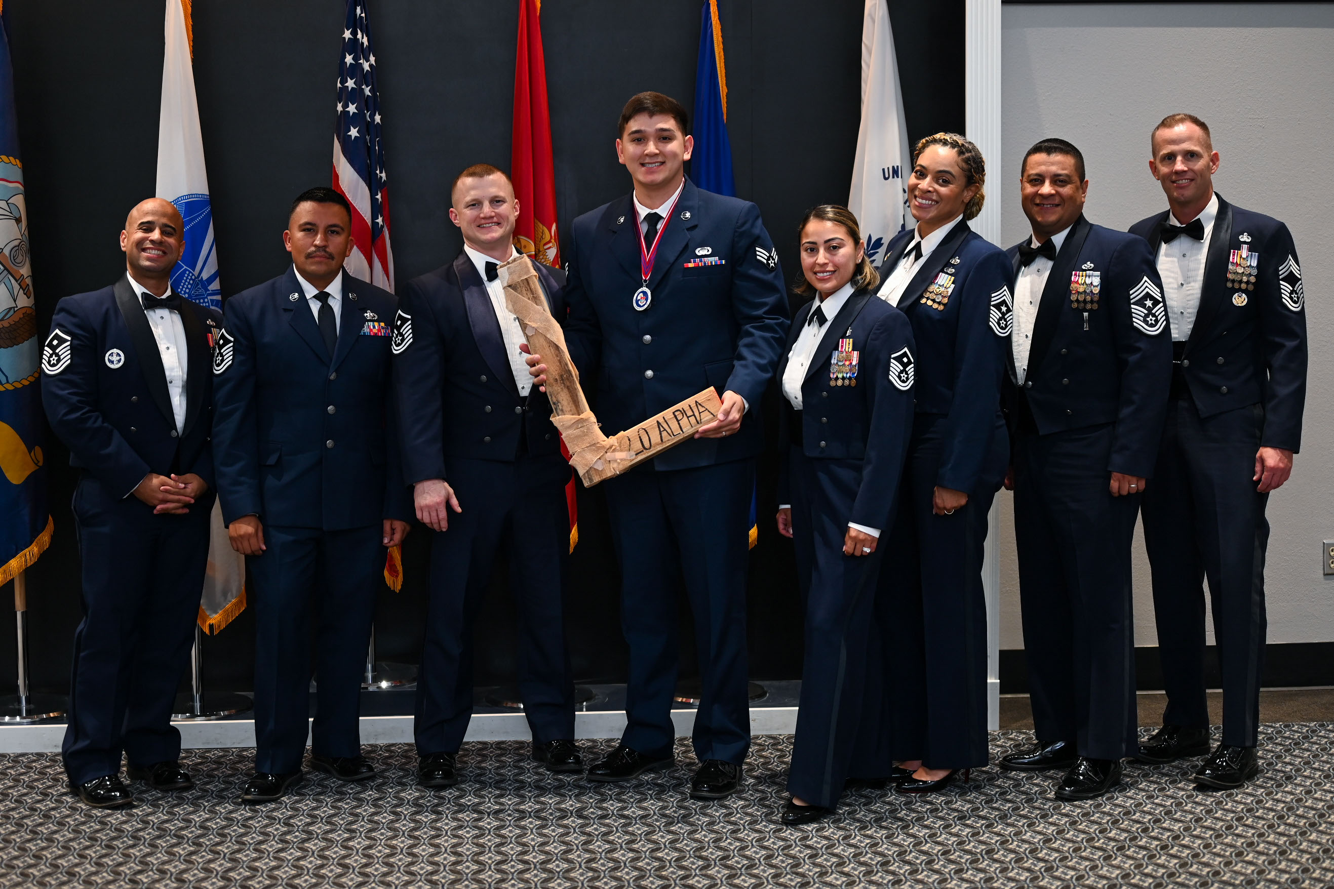 U.S. Air Force Senior Airman Cade Kennedy, Airman Leadership School Class 25-D class lead, takes the “L” from the Top 3 council, during the ALS Class 25-B graduation at the Powell Event Center, Goodfellow Air Force Base, Texas, May 22, 2025. Every ALS class plays a volleyball game with the first sergeants and the winning team presents the “L” to the losing team at graduation. (U.S. Air Force photo by Senior Airman Evelyn J. D’Errico)