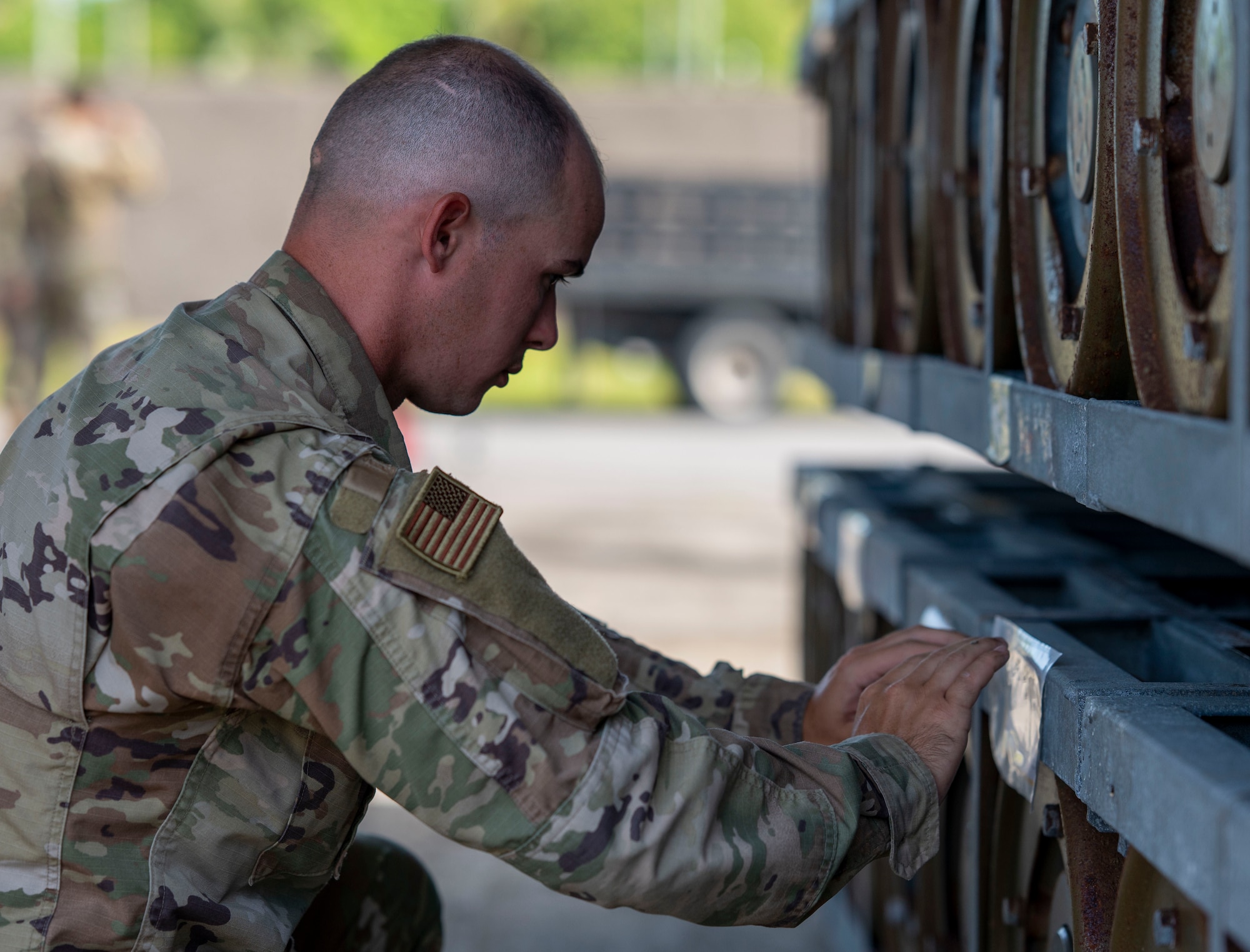 Senior Airman Lux Edmonson, 36th Mission Support Group Det. 1 Munitions Inspector, replaces a description tag for munitions at Diego Garcia, British Indian Ocean Territory, May 15, 2025.