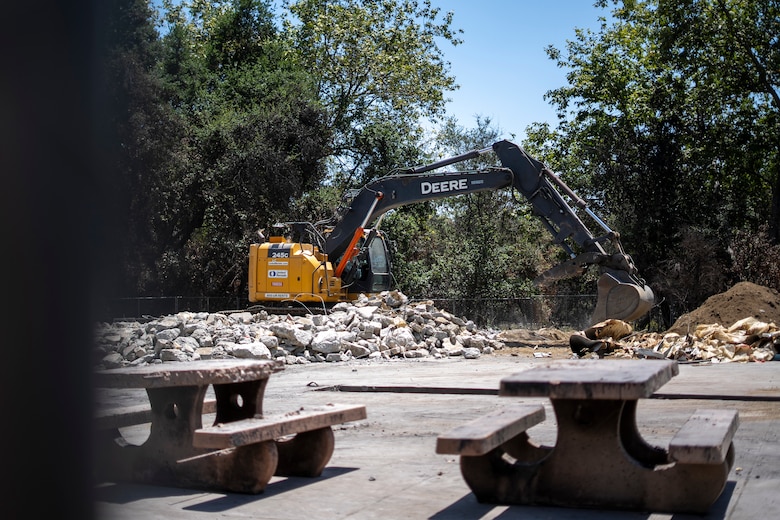 A contractor uses an excavator to remove concrete debris at the Native Plant Garden at Eaton Canyon Nature Center in Altadena, California, May 23, 2025. The effort is part of a broader wildfire recovery and debris removal mission managed by the U.S. Army Corps of Engineers.