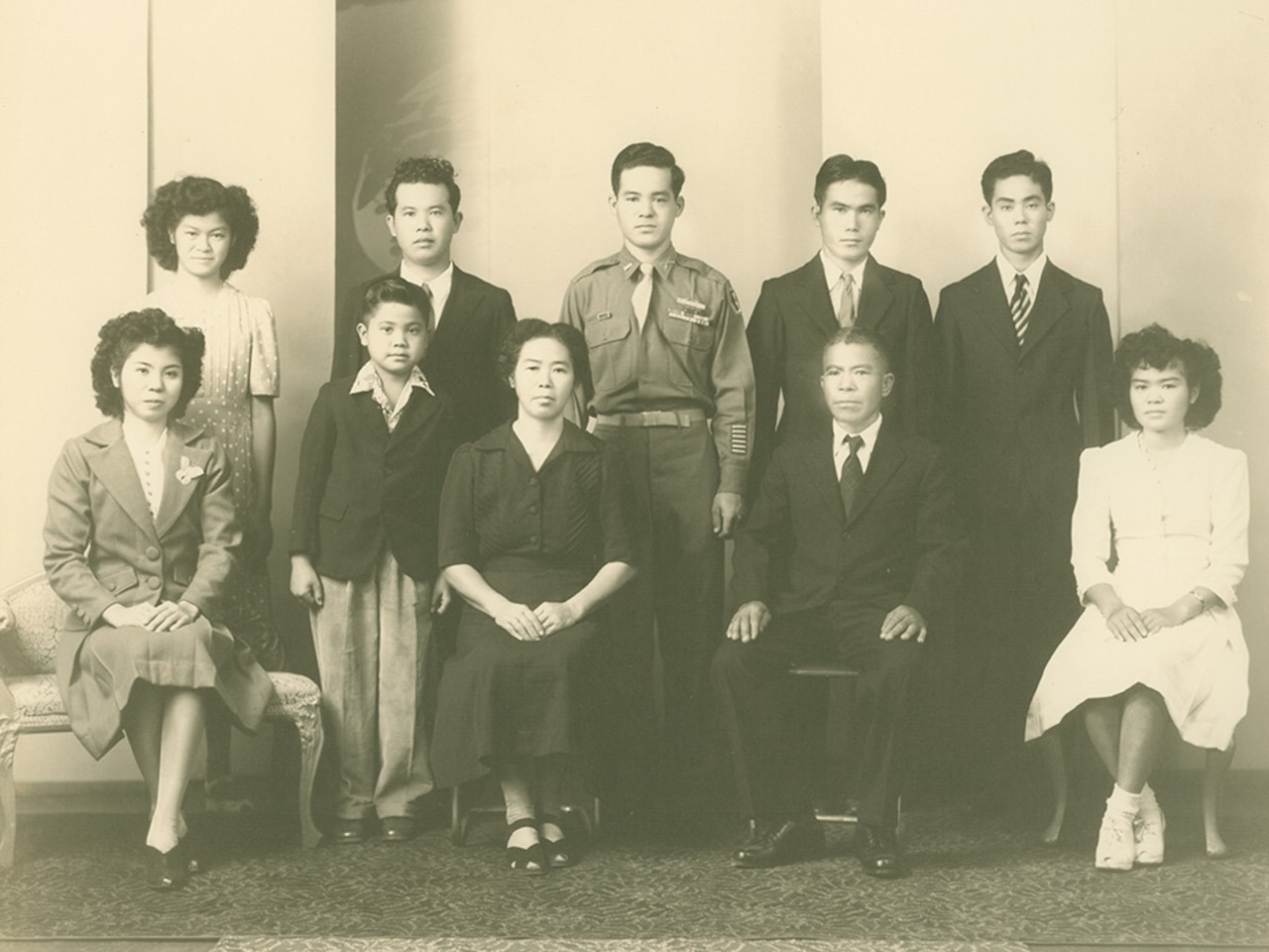 Ten people, four of whom are seated, pose for a photo.