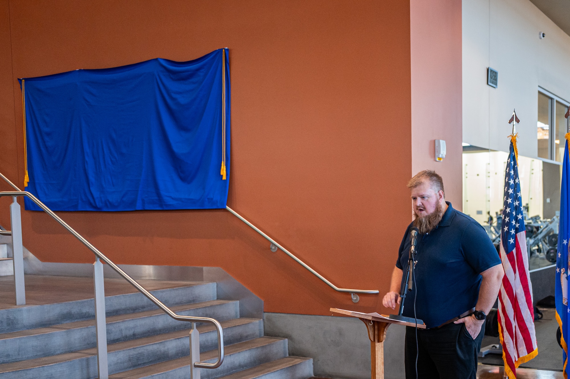Man stands by stairs.
