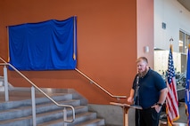 Man stands by stairs.