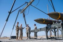 U.S. Air Force Chief of Staff Gen. David Allvin and Airmen assigned to the 9th Munitions Squadron (MUNS) discuss the operations of the Air Force Combat Ammunition Center at Beale Air Force Base, California, May 28, 2025.