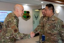 U.S. Air Force Chief of Staff Gen. David Allvin, left, coins Tech Sgt. Justin To, 147th Combat Communications Squadron radio frequency trainer, during a visit at Beale Air Force Base, California, May 28, 2025.