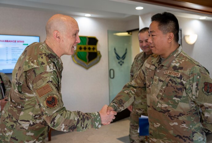 U.S. Air Force Chief of Staff Gen. David Allvin, left, coins Tech Sgt. Justin To, 147th Combat Communications Squadron radio frequency trainer, during a visit at Beale Air Force Base, California, May 28, 2025.