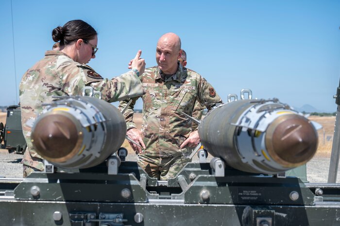 U.S. Air Force Chief of Staff Gen. David Allvin and Tech Sgt. Kieran Kelly, 9th Munitions Squadron (MUNS) Air Force Combat Ammunition Center (AFCOMAC) instructor, inspect GBU-38 bombs during a visit to Beale Air Force Base, California, May 28, 2025.